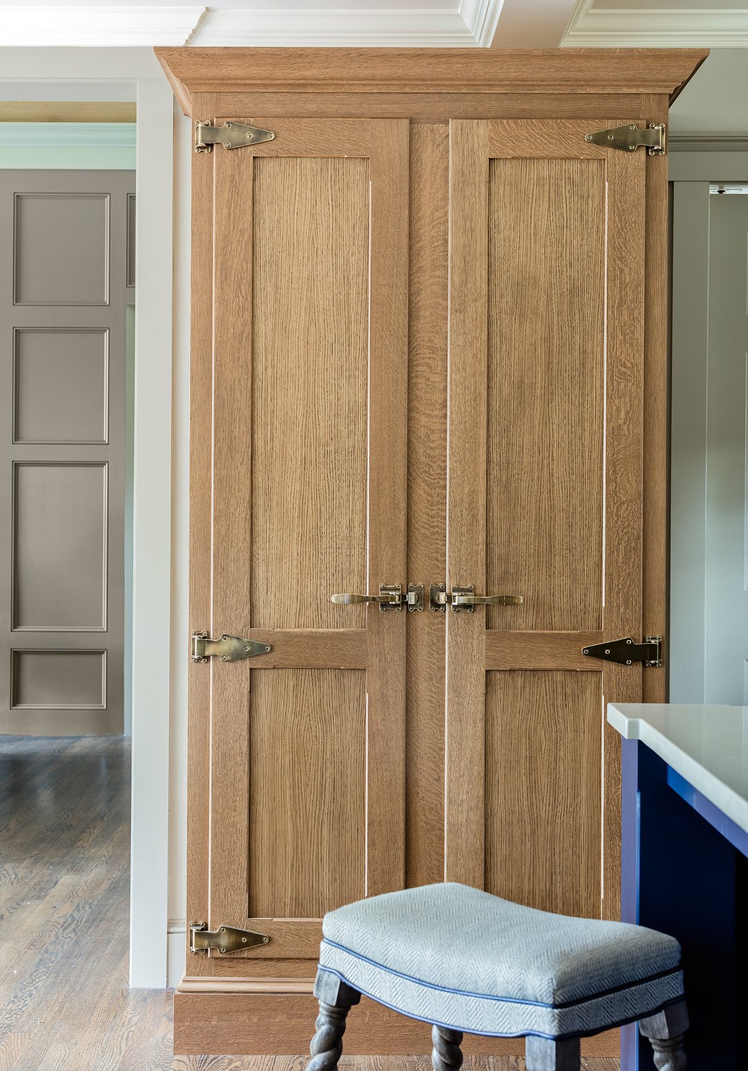 Custom white oak pantry doors with antique brass strap hinges — bespoke kitchen millwork in Essex County MA by Sacris Design, serving southern NH and Maine