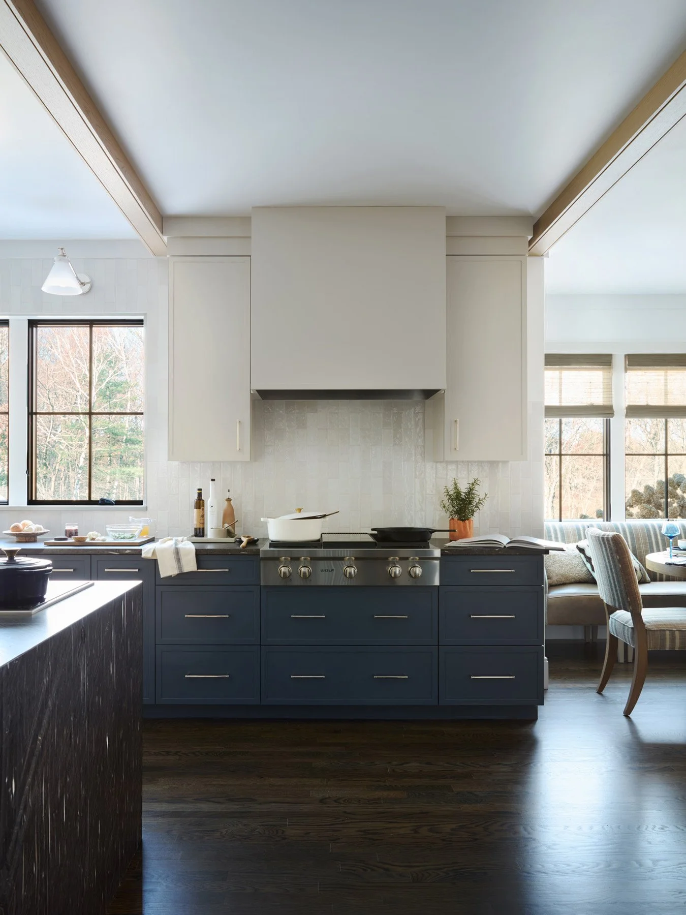 SACRIS kitchen with four-burner griddle Wolf gas rangetop, custom plaster hood, navy cabinetry and glazed stack tile backsplash, North Andover Massachusetts