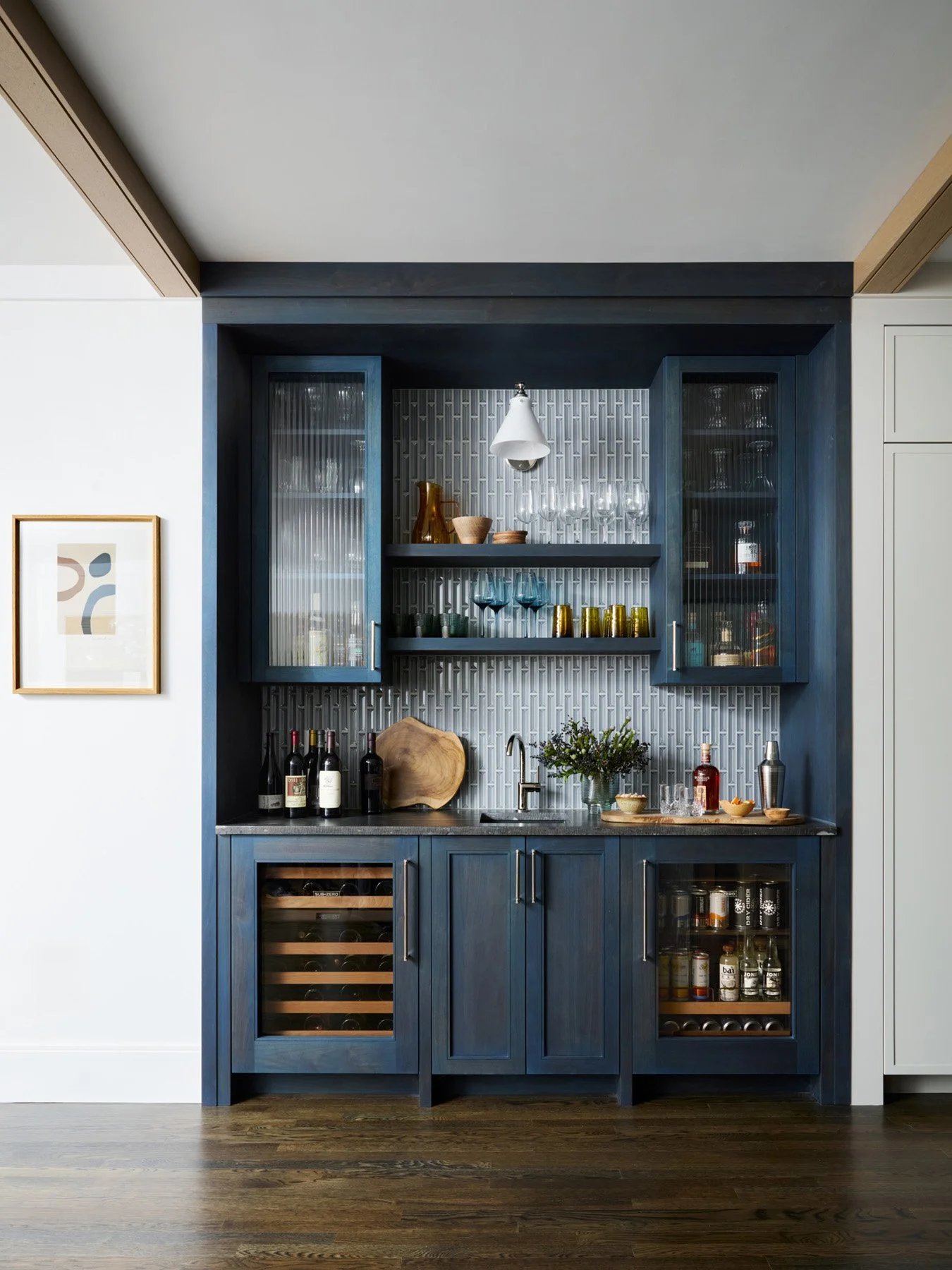 SACRIS bar area in indigo oil-stained walnut with reeded glass cabinetry, Sub-Zero wine storage and beverage center, and vertical mosaic tile, North Andover Massachusetts