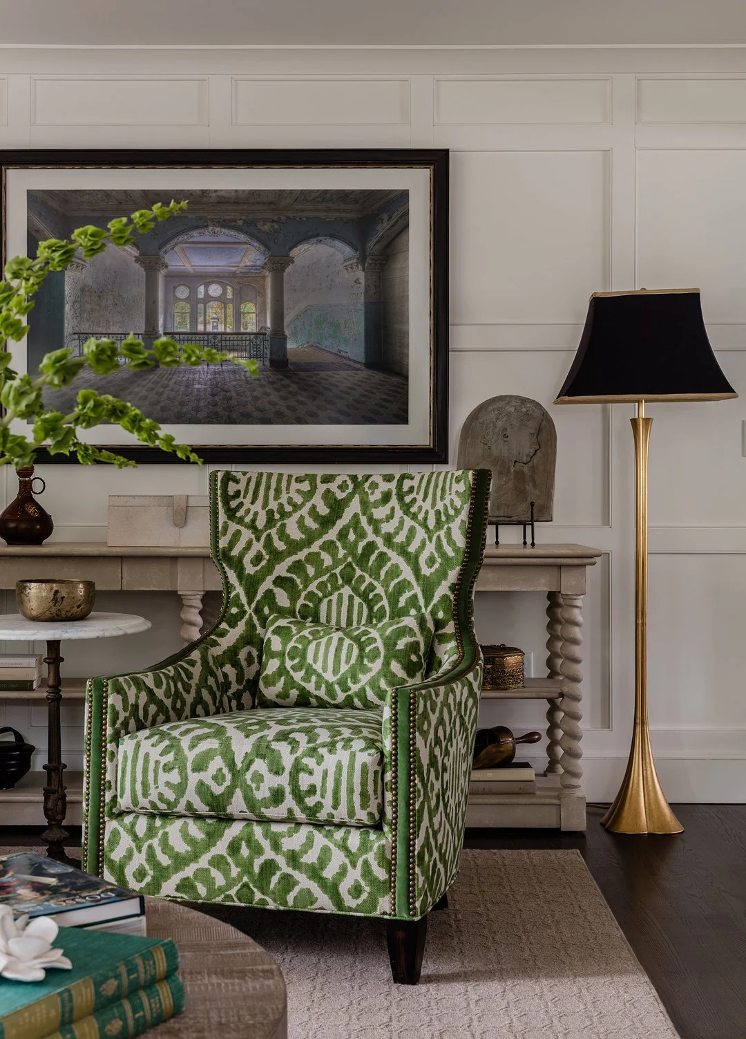 Sacris Design high end living room with custom green ikat wingback chair and painted panel millwork, serving Southern New Hampshire