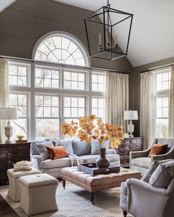 Living room with palladian windows, extra large Darlana lantern, grasscloth walls, drapery panels and traditional custom upholstered furniture
