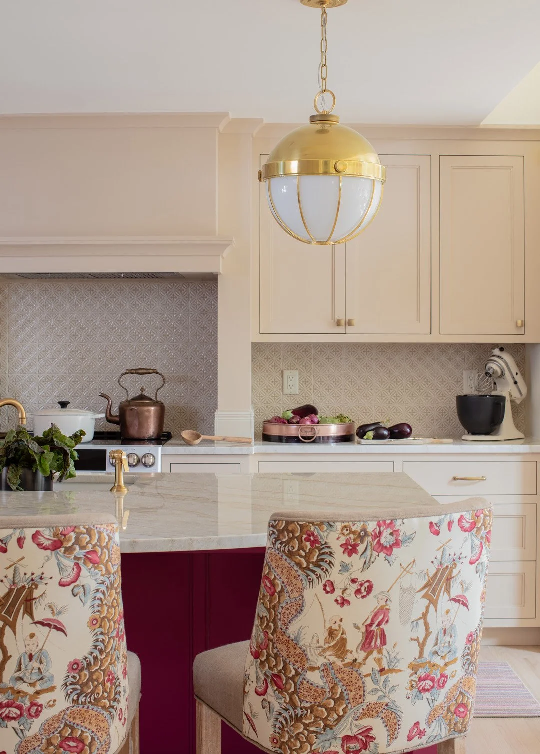 Sacris Design New Castle New Hampshire kitchen with tan cabinetry, decorative patterned glazed tile backsplash and toile upholstered barstools, Portsmouth NH