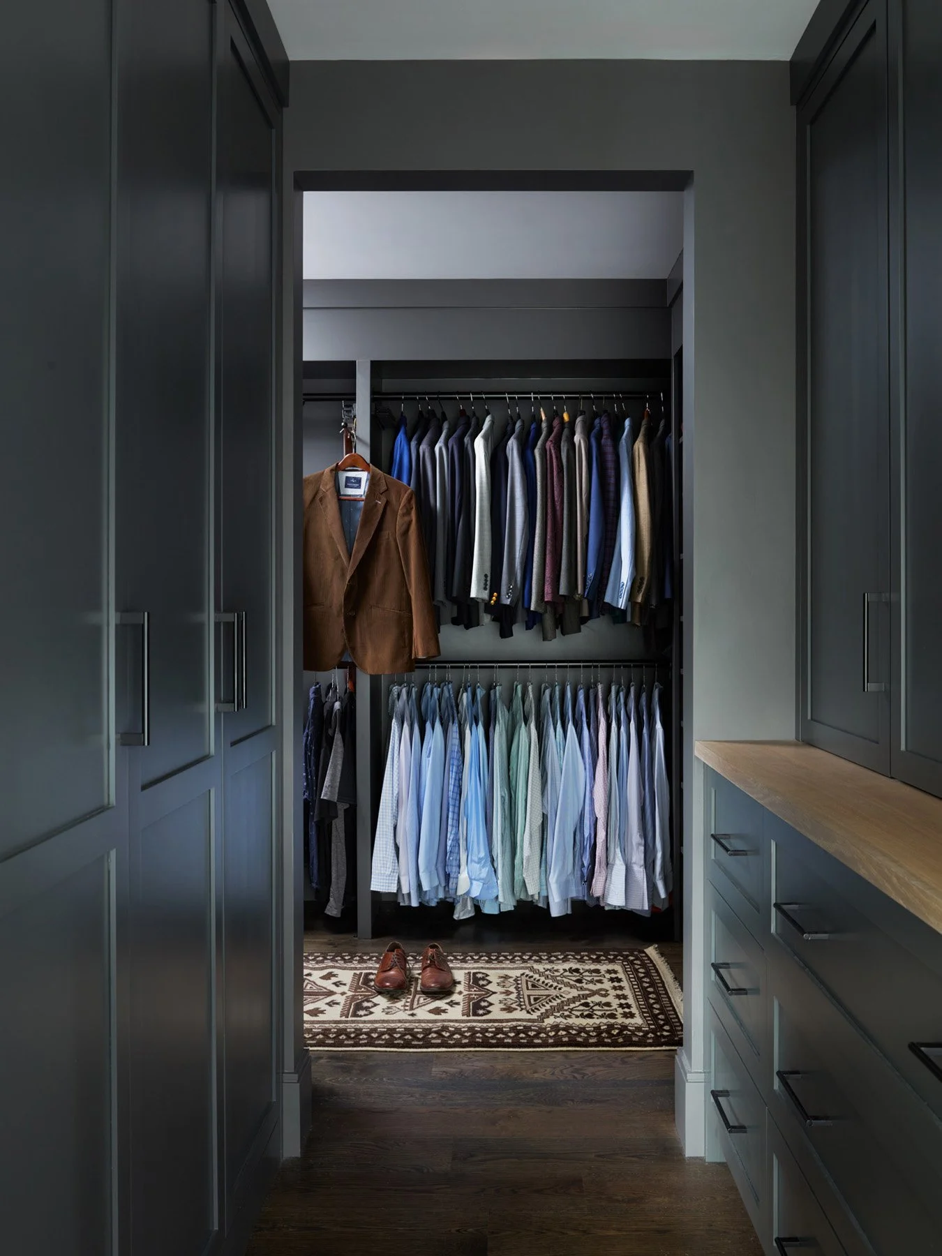 SACRIS dressing room with custom slate-blue cabinetry, white oak counter and integrated hanging storage, North Andover Massachusetts