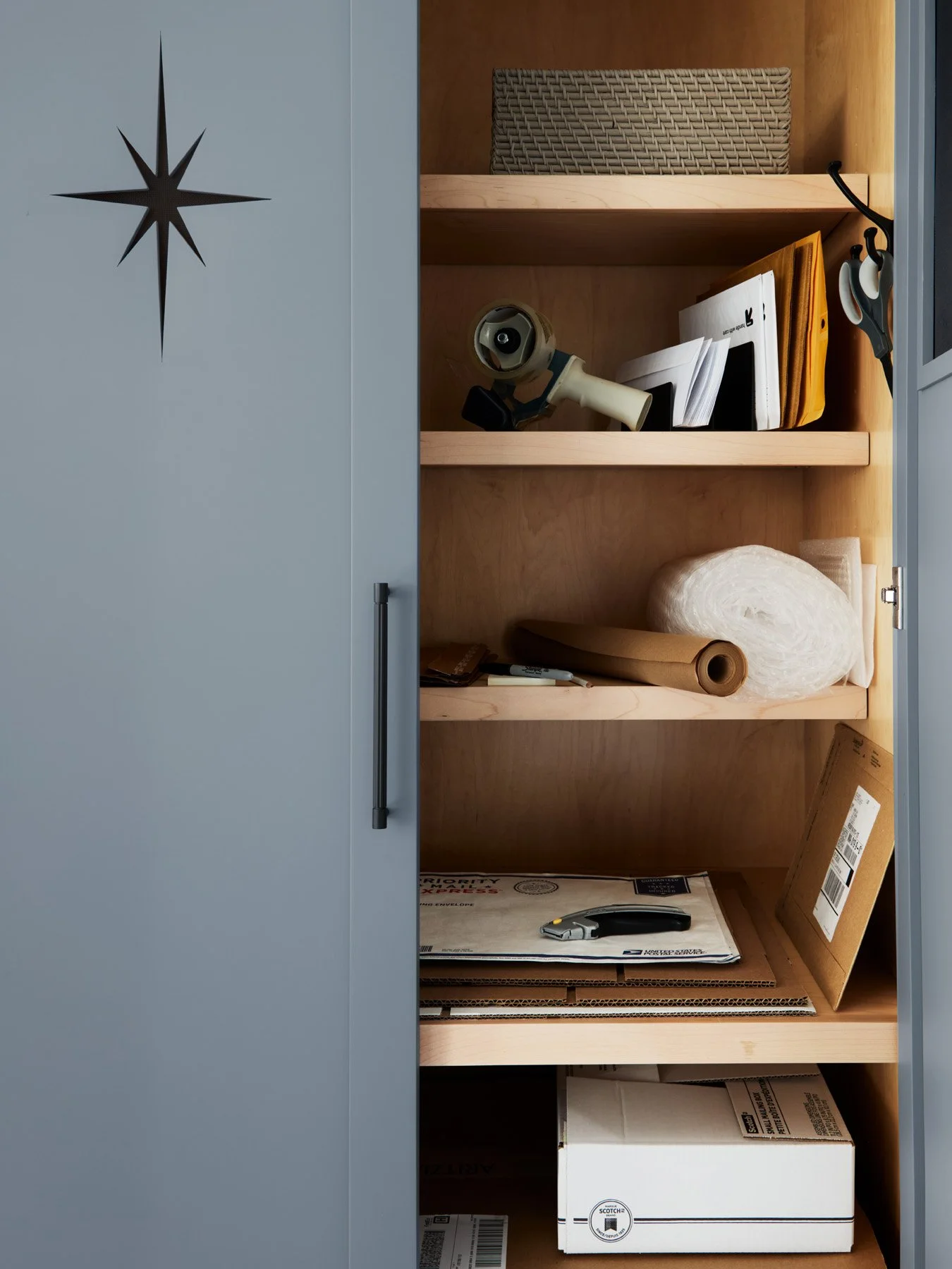 SACRIS concealed shipping and mailing station within mudroom cabinetry, with maple interior shelving, North Andover Massachusetts