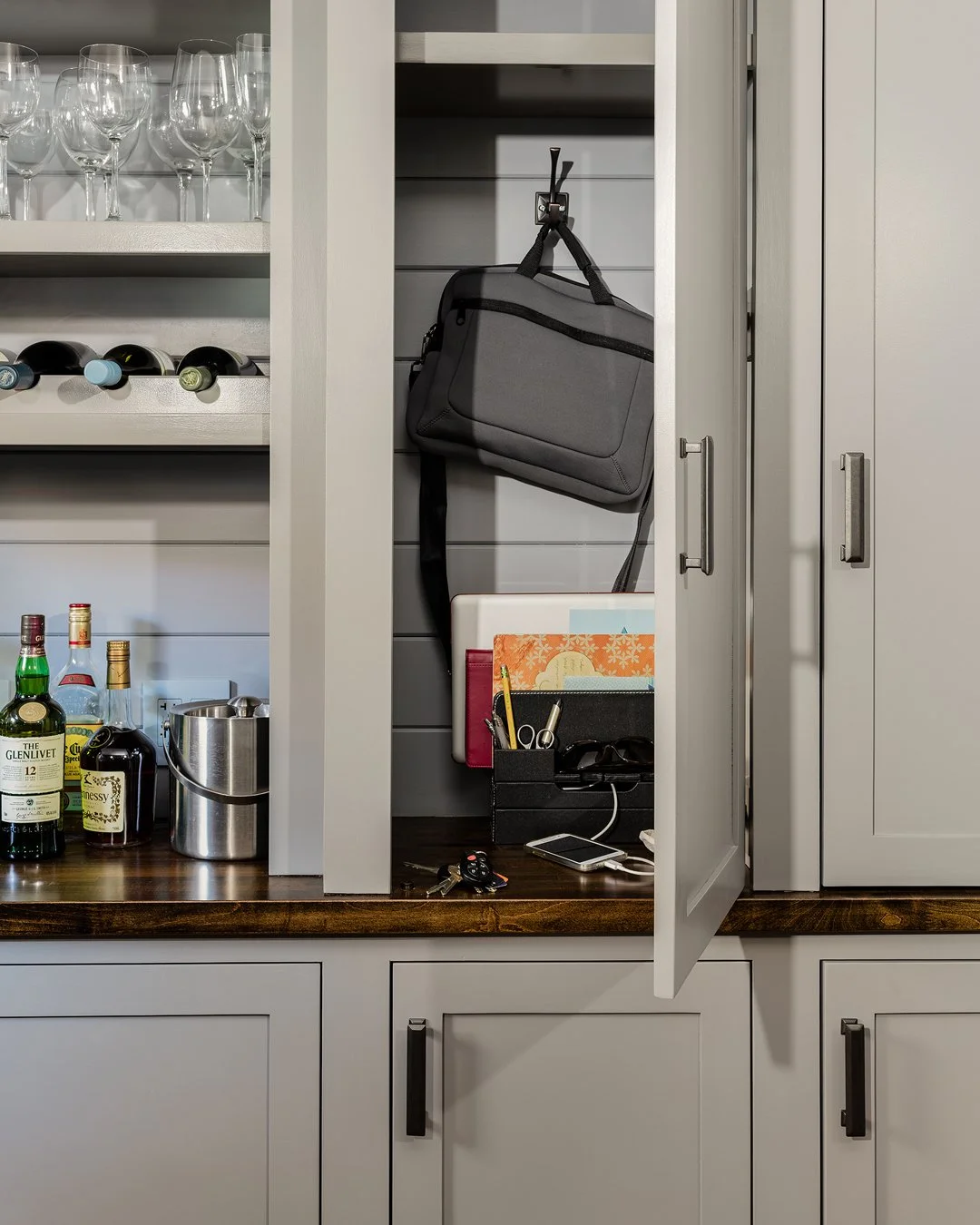 Butler's pantry with hidden charging station, hook storage, wine rack, and walnut countertop — custom cabinetry design by Sacris Interior Architecture & Design, serving Essex County MA and York County Maine 