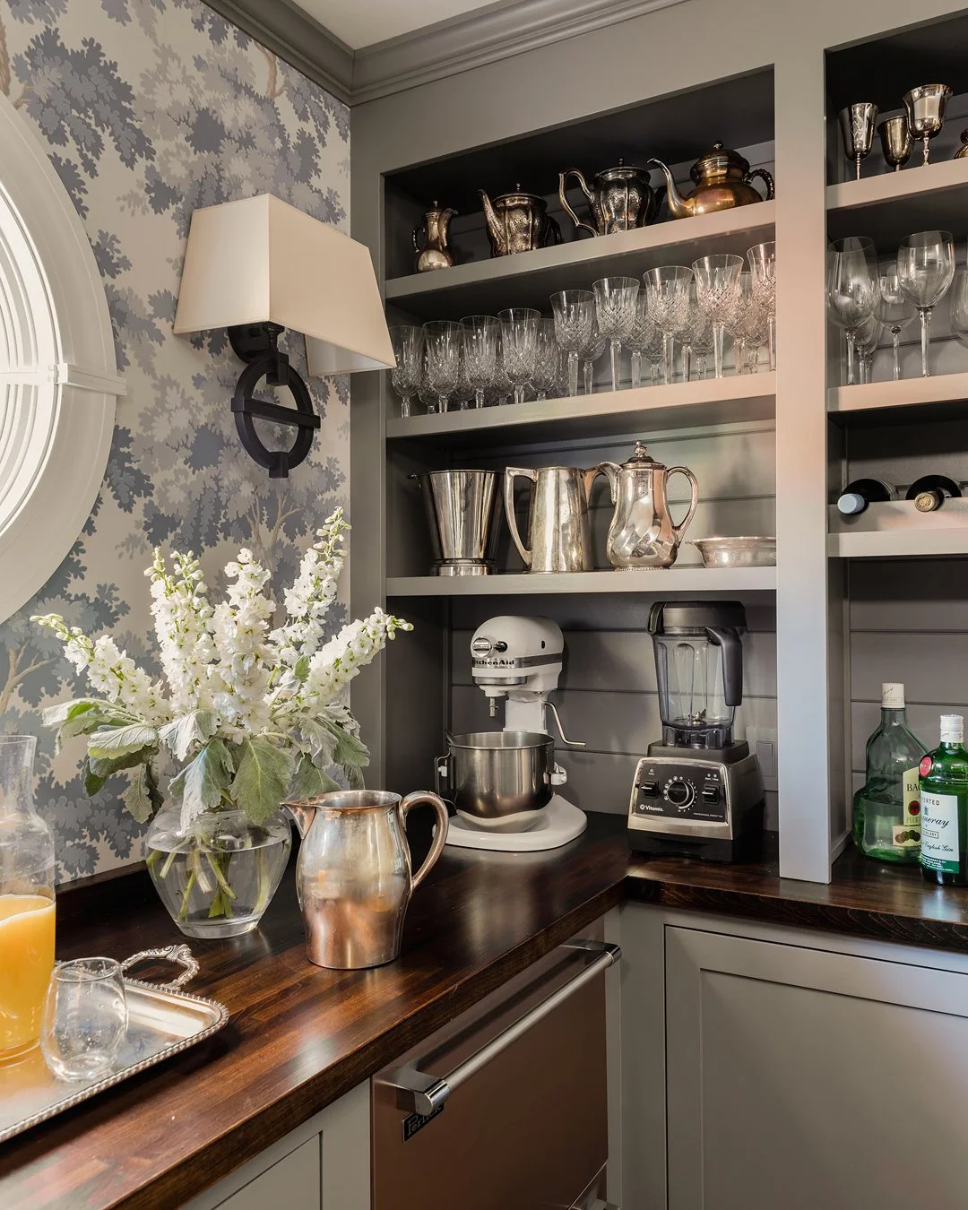 Butler's pantry detail with antique silver collection, glassware, tree wallpaper, and walnut stained countertop — traditional luxury interior design on the North Shore of Massachusetts by Sacris Design