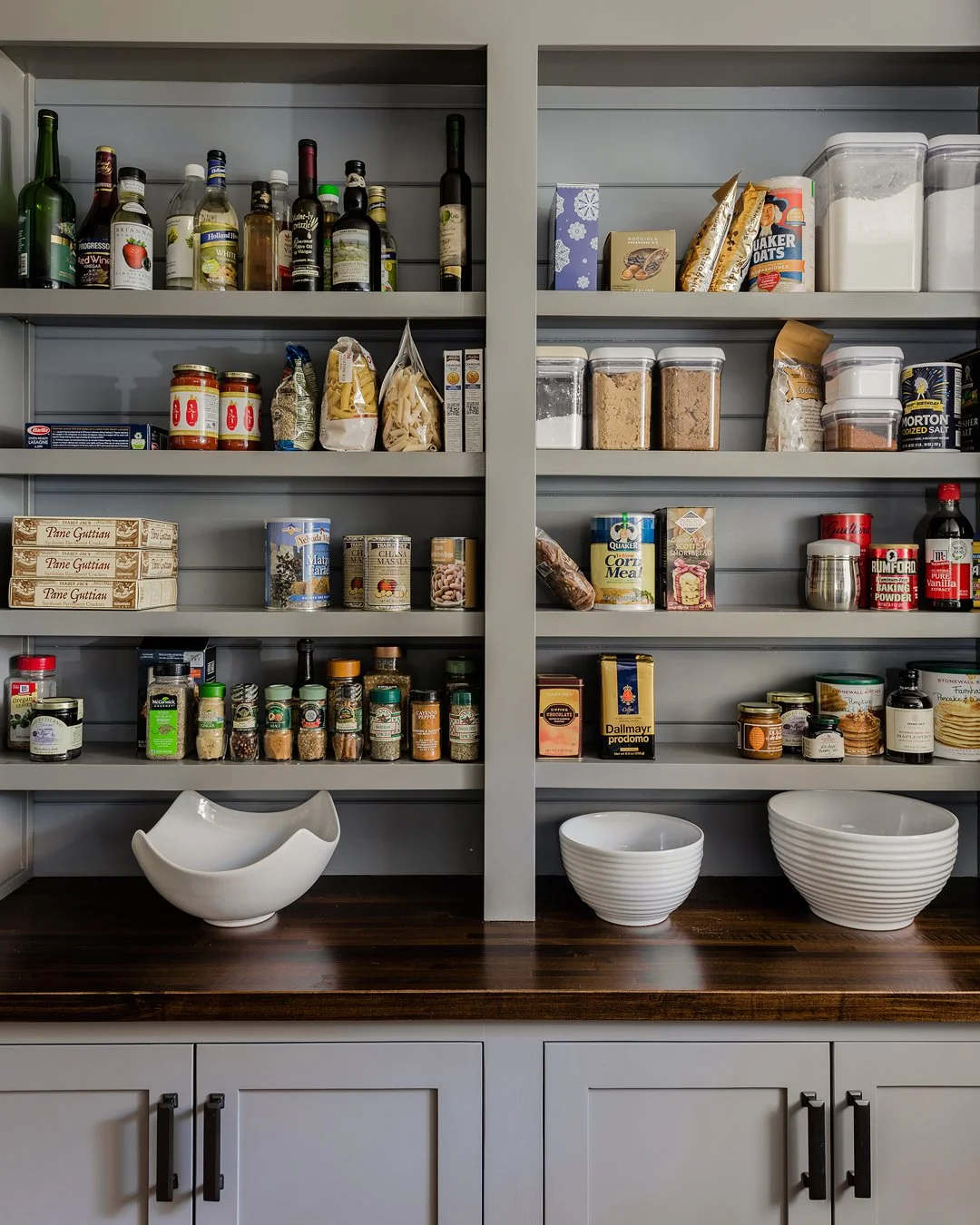 Custom built-in pantry with gray painted shaker cabinetry, open shelving, and walnut stained countertop — bespoke kitchen millwork and interior architecture in Essex County MA by Sacris Design
