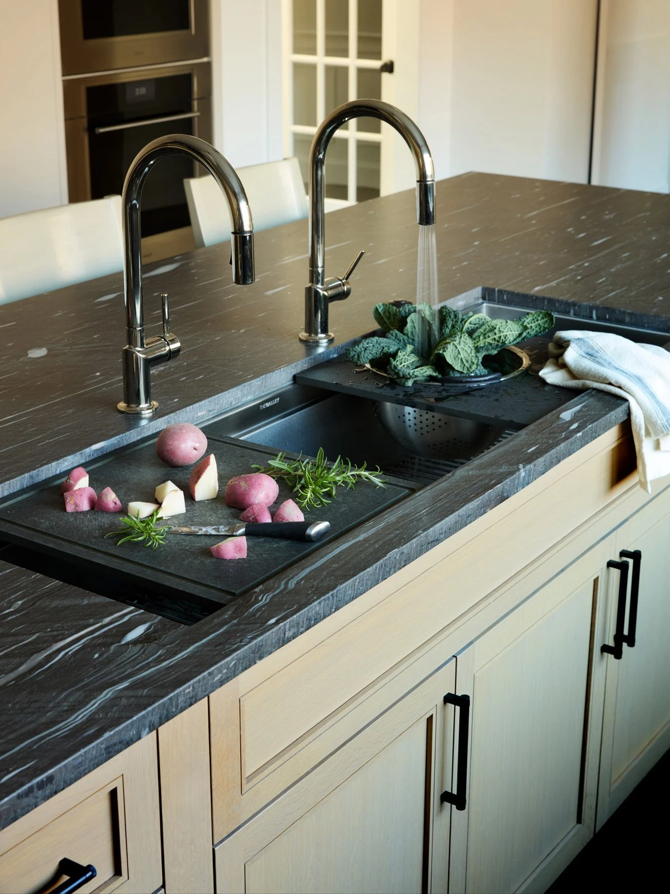 SACRIS island detail with Galley multifunction workstation sink, integrated prep board and colander, and polished nickel faucets, North Andover Massachusetts