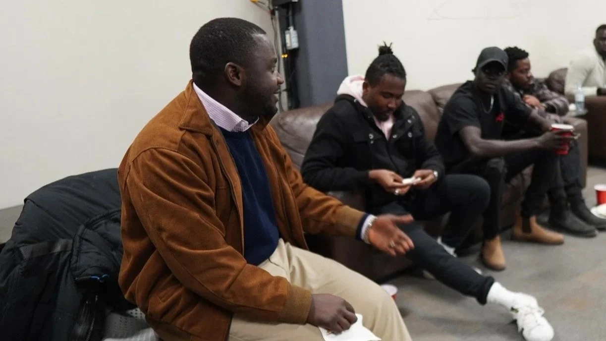 Modern house with wooden exterior, stone steps, and a mountain landscape in the background.
