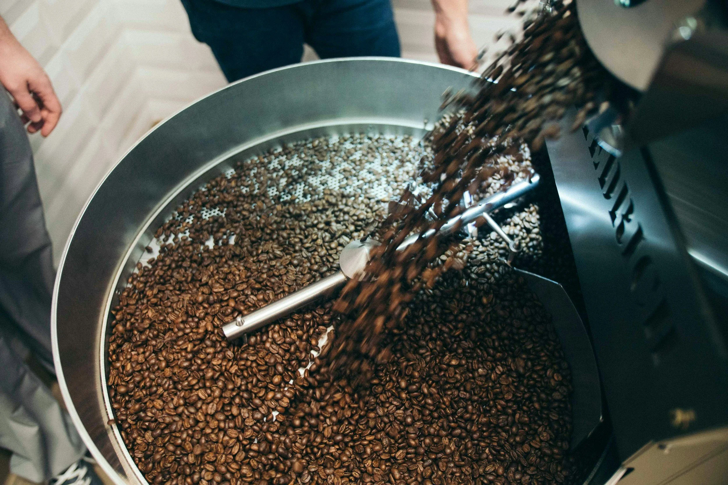 Coffee beans being roasted in a commercial roasting machine.