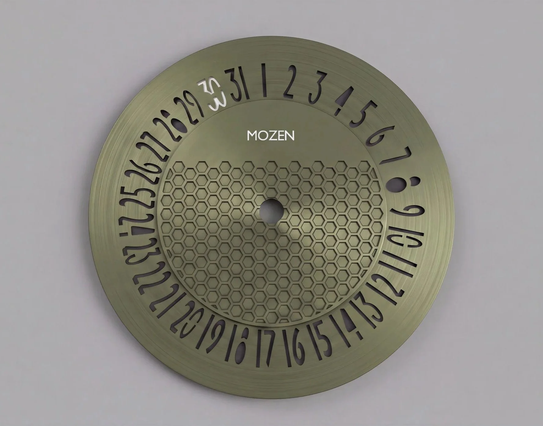 A green circular calendar with black numbers from 1 to 31 arranged in a circle around the perimeter, with the word 'MOZEN' in the center and a honeycomb pattern behind it. The center hole indicates this is a decorative or functional calendar disk.