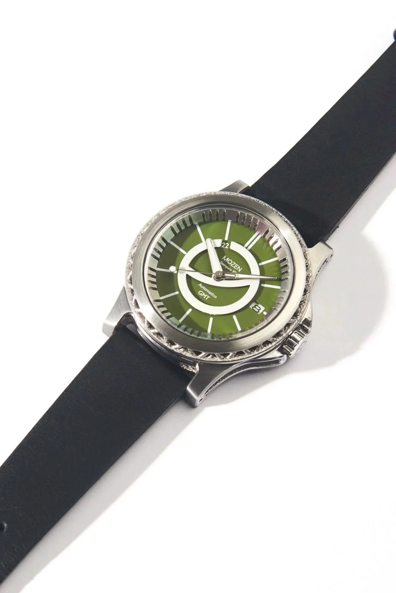 A wristwatch with a green dial, black strap, and silver case, displaying the time and date.