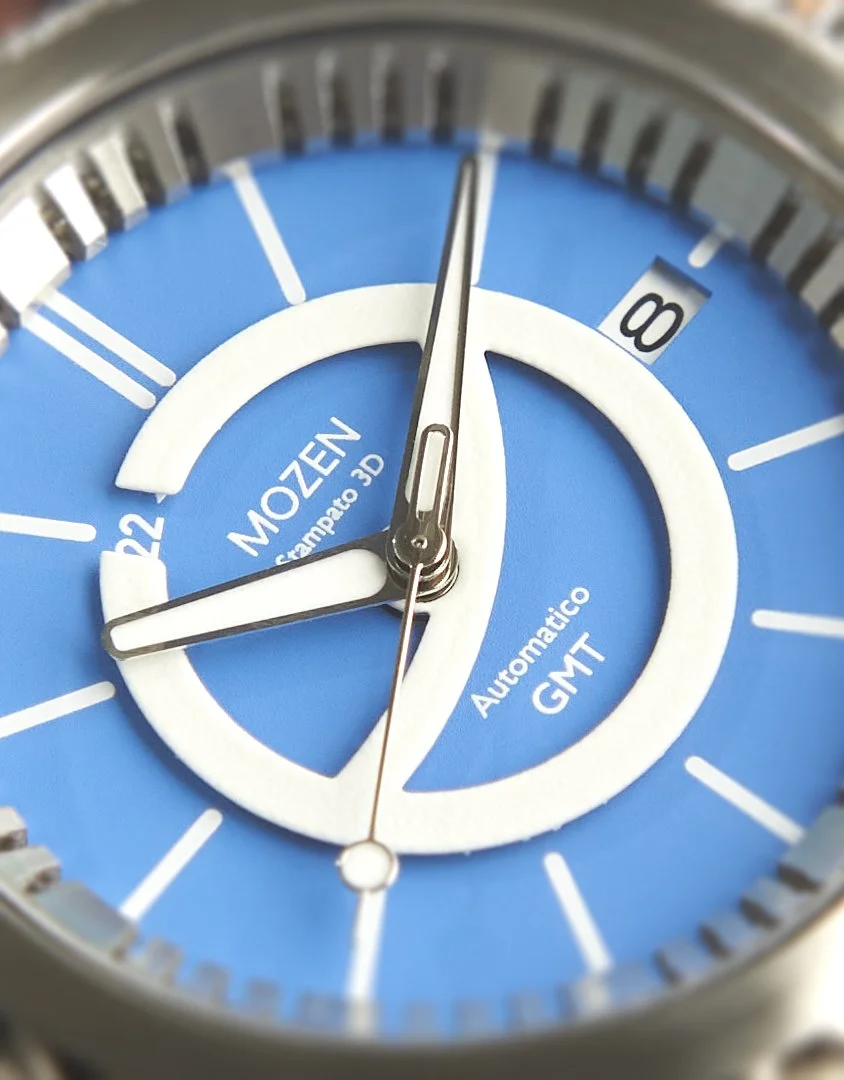 Close-up of a blue and white Citizen automatic GMT wristwatch showing the time, with a date window displaying the number 8.