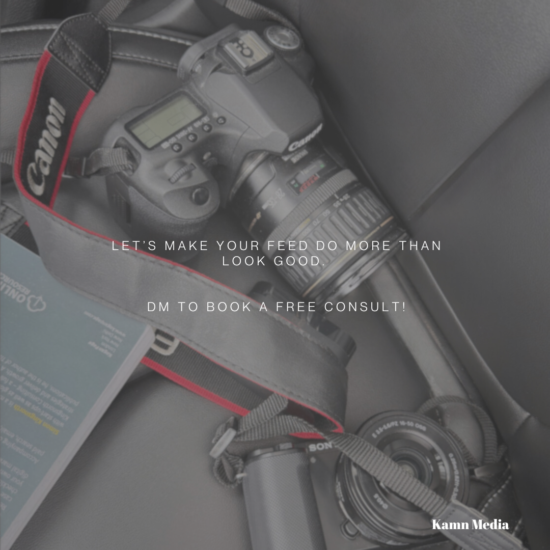 A Canon camera with a zoom lens, a Sony camera, and a brochure on a car seat.
