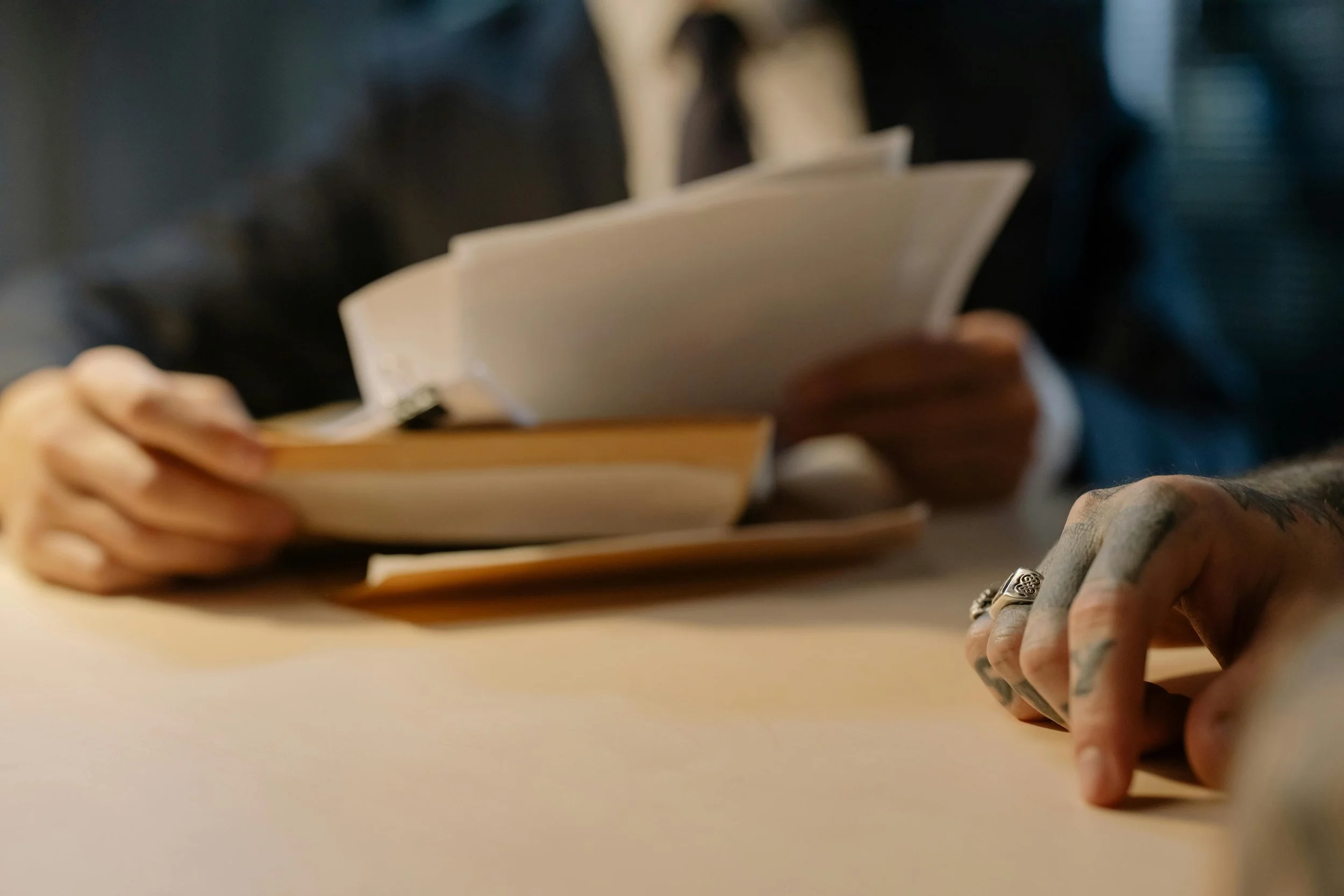 Hands reading legal documents to understand the original bill language.