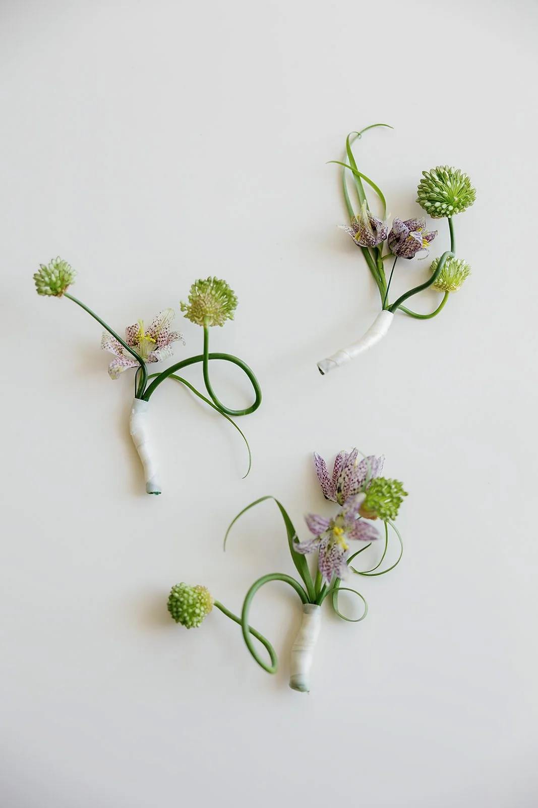 Minimal boutonnieres at a Merv Griffin Estate wedding with outdoor green garden party decor designed by COJ Events