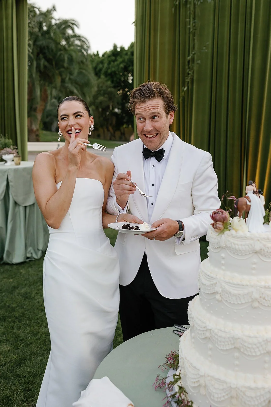 A bide and groom eating wedding cake at their Merv Griffin Estate wedding reception designed by COJ Events