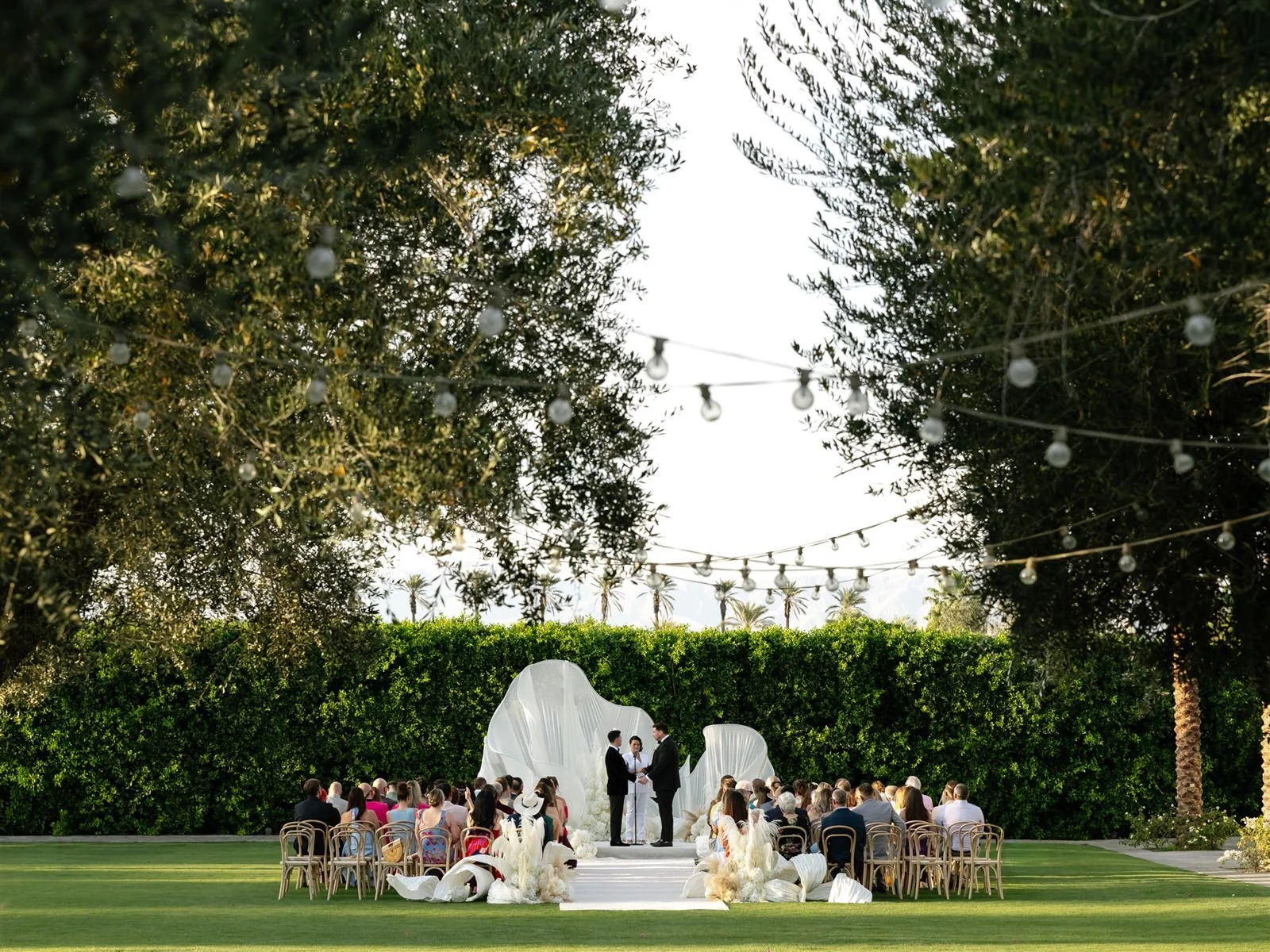 Two grooms during their Cache Estate wedding ceremony in Indio, CA, by Palm Springs wedding planner COJ Events