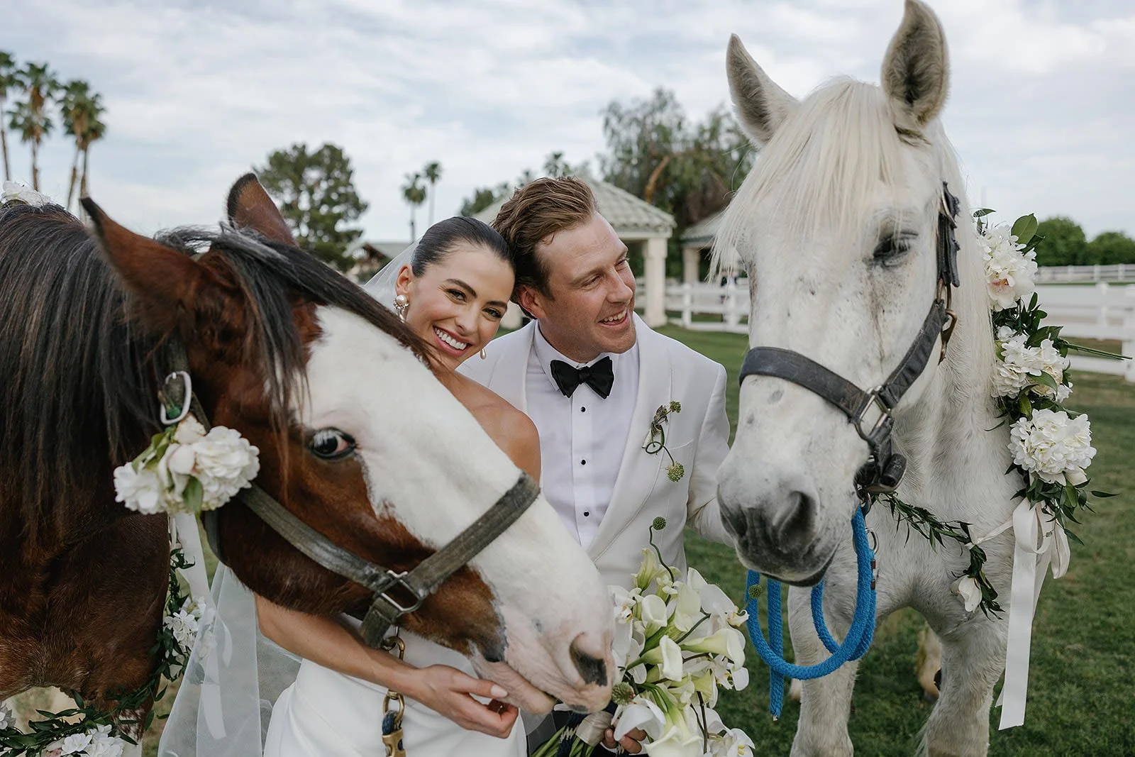 Bride and groom with horses at a Merv Griffin Estate wedding designed by COJ Events