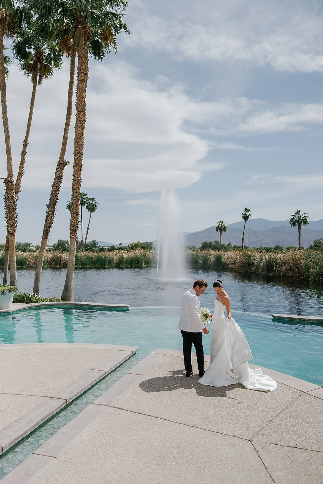 Bride and groom a Merv Griffin Estate wedding with outdoor green garden party decor designed by COJ Events