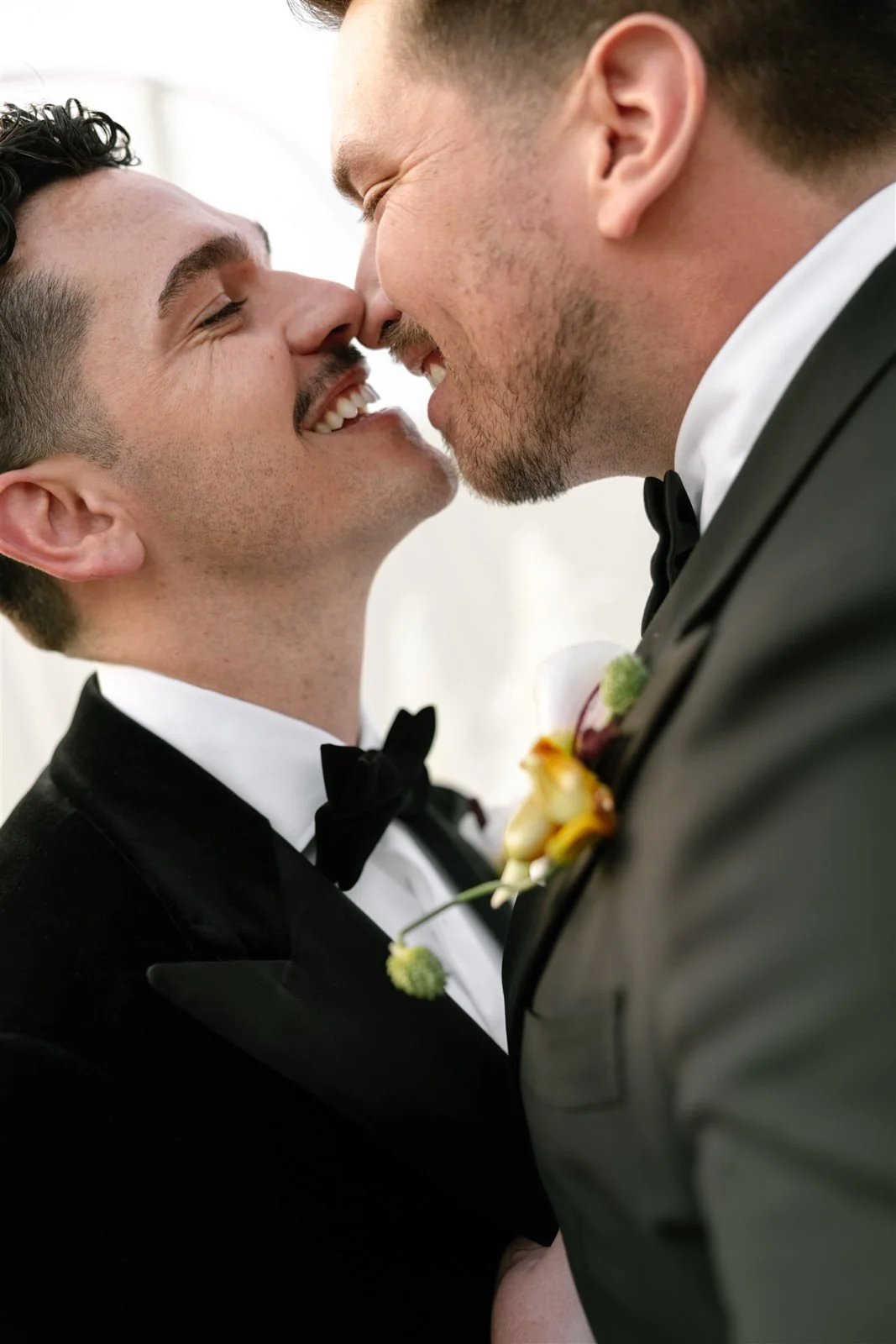 Two grooms smiling and kissing after their Cache Estate wedding ceremony in Indio, CA, by Palm Springs wedding planner COJ Events