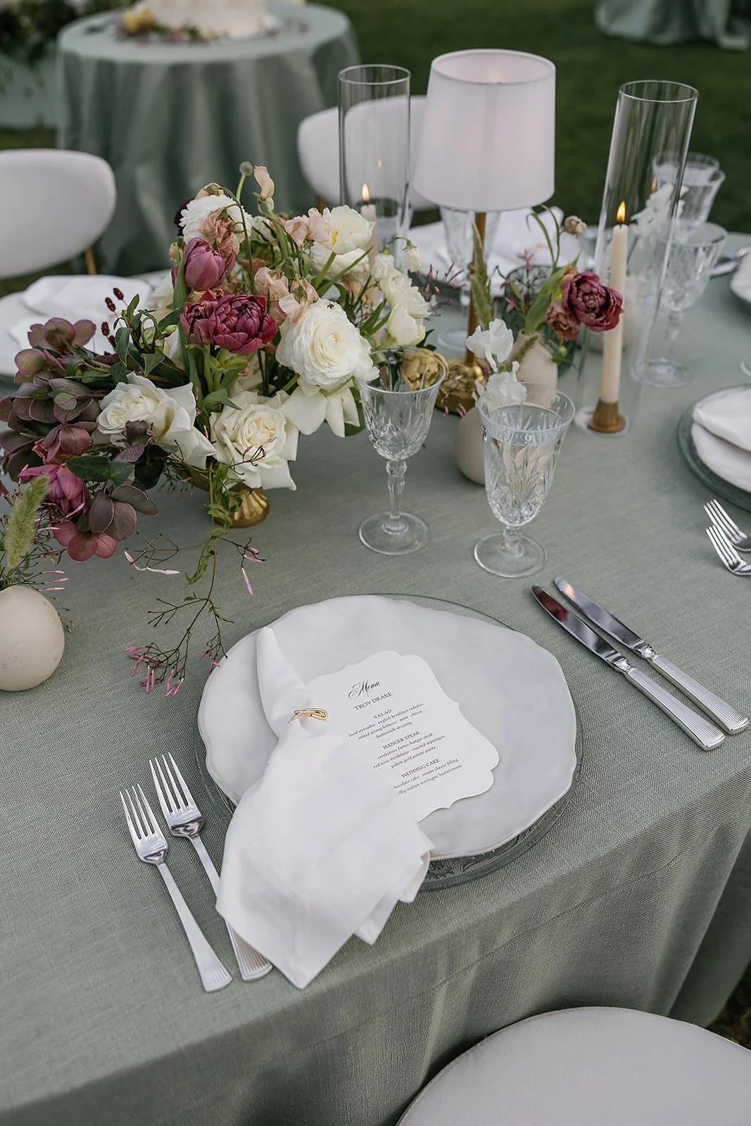 A pretty place setting at a Merv Griffin Estate wedding reception with outdoor green garden party decor designed by COJ Events