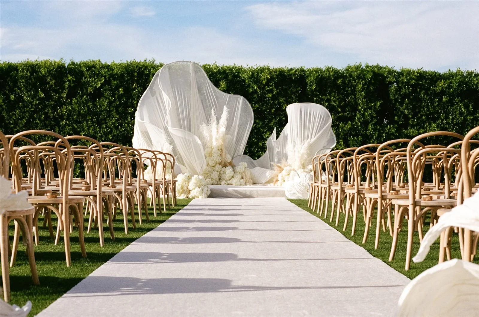 Avant garde white wedding ceremony design at Cache Estate Wedding in Indio, CA, by Palm Springs wedding planner COJ Events