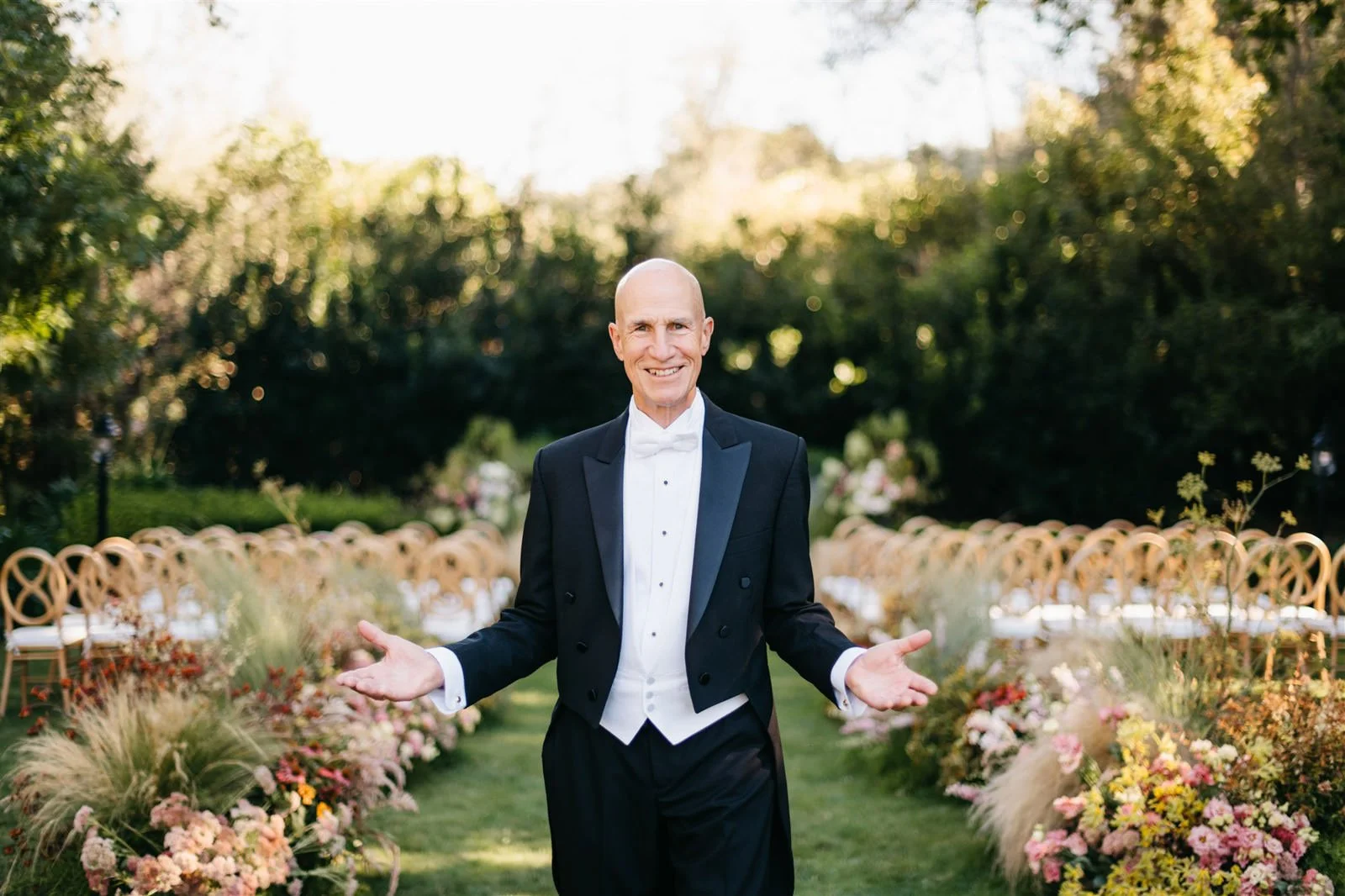 Bride's father waiting by the ceremony area filled with florals of purple coneflower, white hydrangeas and grasses with a woodland vibe on the grounds of The Madrona -Planned by COJ Events-Palm Springs Destination Wedding