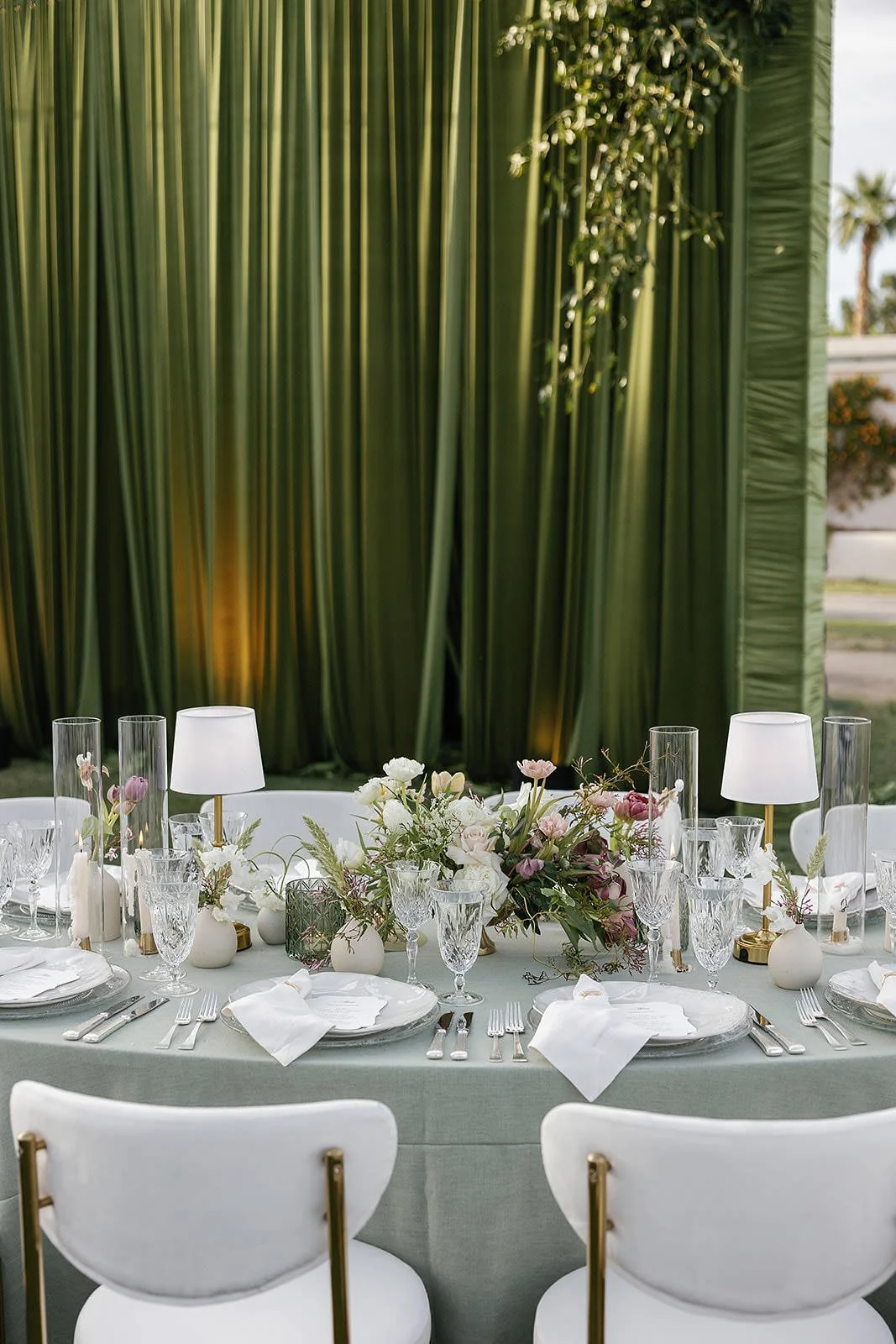 Dining tables at a Merv Griffin Estate wedding reception with outdoor green garden party decor designed by COJ Events