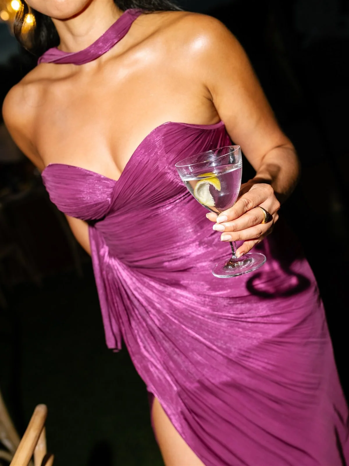 Guest in a pink dress with a cocktail at a Cache Estate wedding reception in Indio, CA, by Palm Springs wedding planner COJ Events