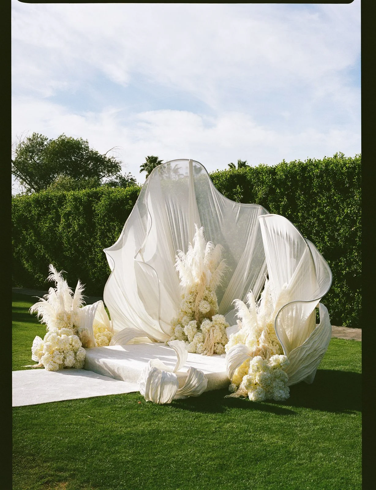 Avant garde white wedding ceremony design at Cache Estate Wedding in Indio, CA, by Palm Springs wedding planner COJ Events