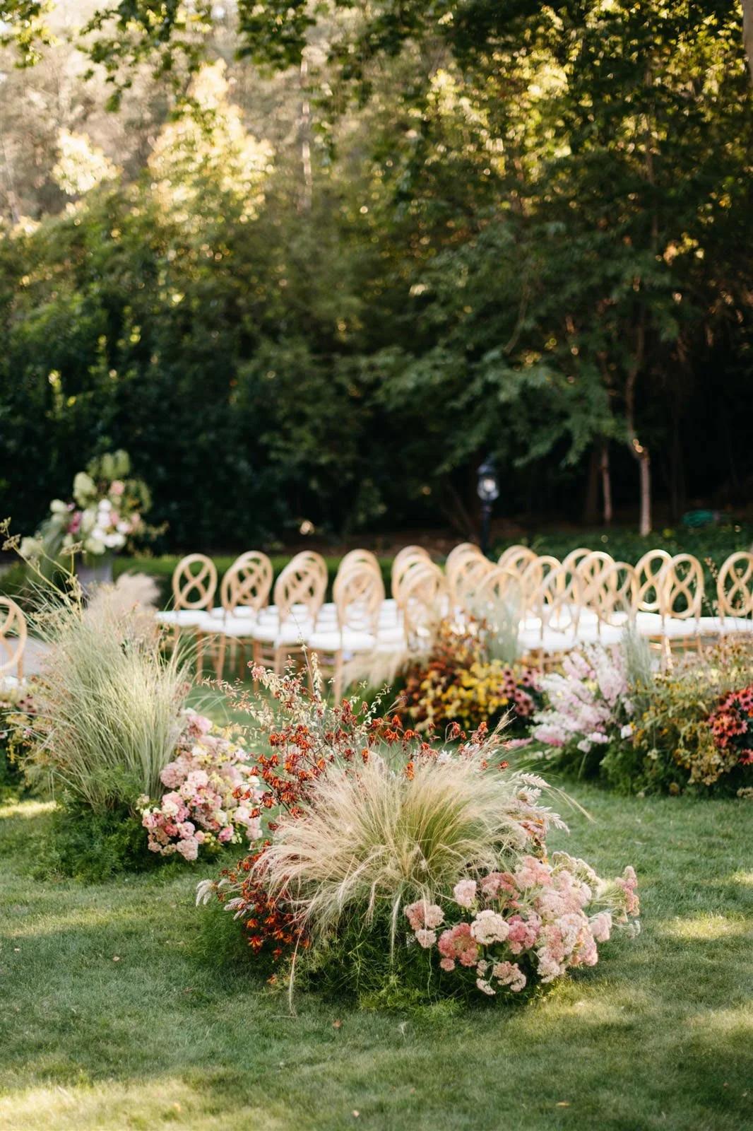 Ceremony area filled with florals of purple coneflower, white hydrangeas and grasses with a woodland vibe on the grounds of The Madrona -Planned by COJ Events-Palm Springs Destination Wedding