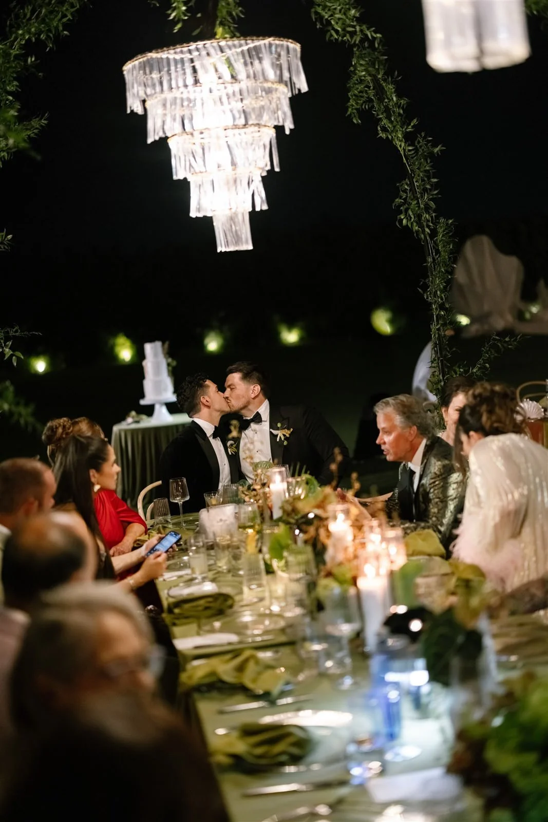 Grooms kissing at their Cache Estate wedding reception in Indio, CA, by Palm Springs wedding planner COJ Events