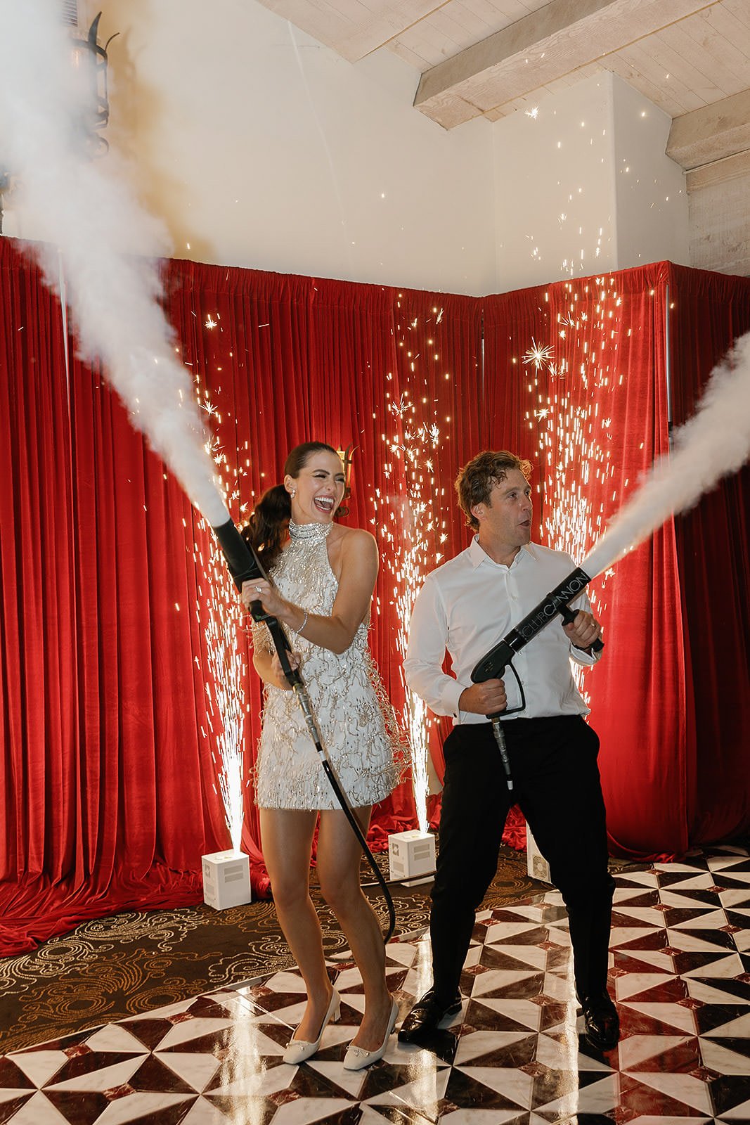 A bride and groom with fog guns on the dance floor at their Merv Griffin Estate wedding, designed by COJ Events