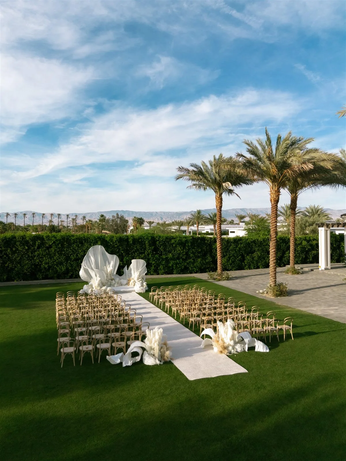 Avant garde white wedding ceremony design at Cache Estate Wedding in Indio, CA, by Palm Springs wedding planner COJ Events