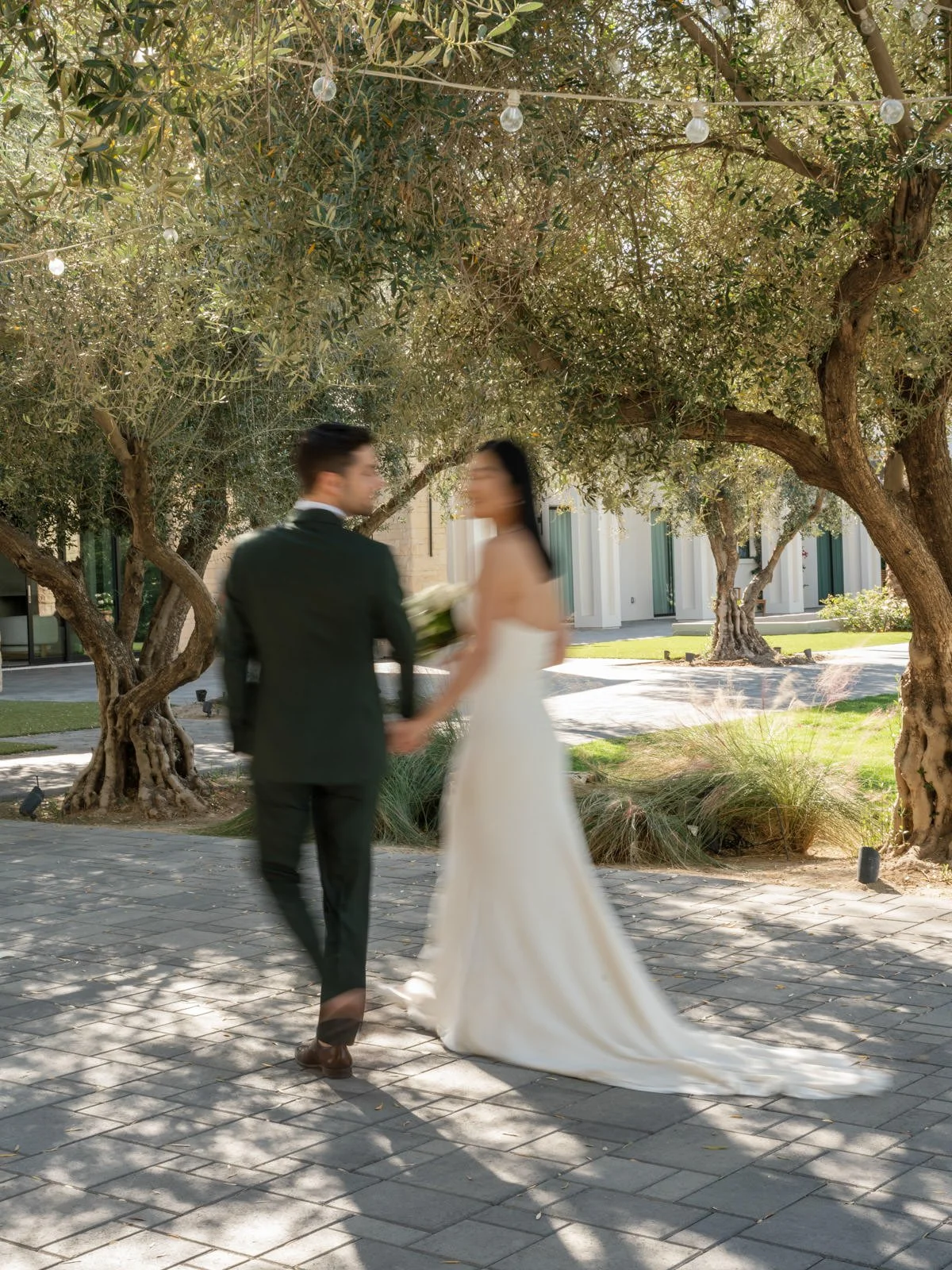 Bride and groom walking through Cache Estate Wedding in Indio, CA, by Palm Springs wedding planner COJ Events