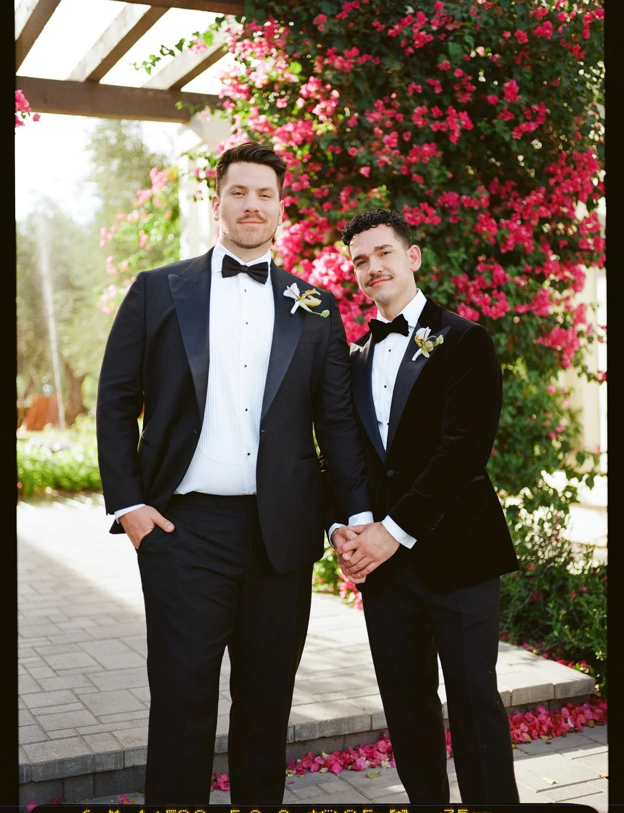 Two grooms in tuxedos at Cache Estate Wedding in Indio, CA, by Palm Springs wedding planner COJ Events