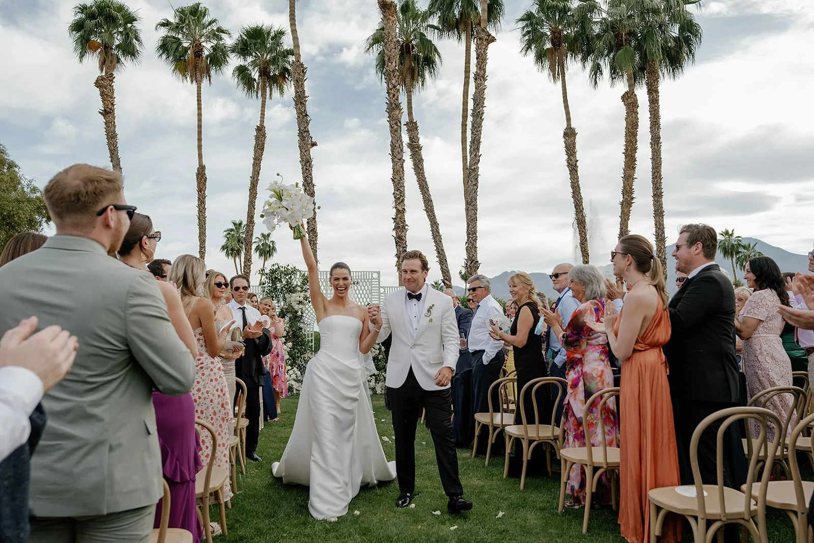 Celebration after a Merv Griffin Estate wedding ceremony with outdoor green garden party decor designed by COJ Events