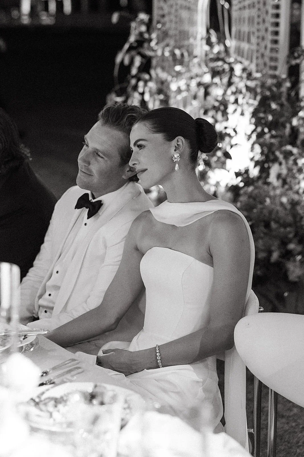 A bide and groom listening to toasts at their Merv Griffin Estate wedding reception designed by COJ Events