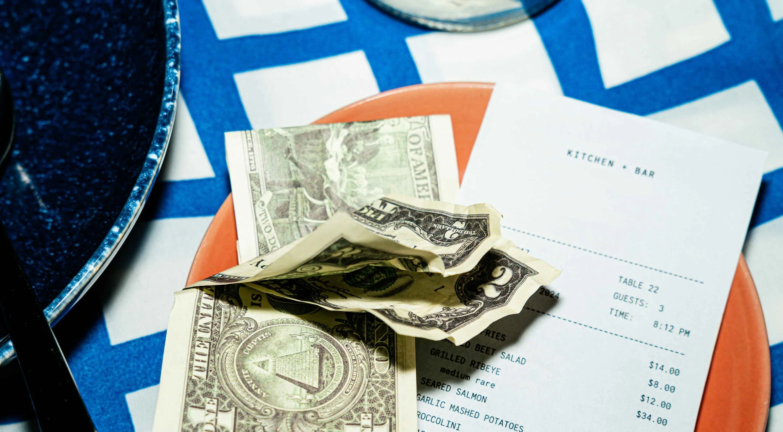 stock image of cash and receipt sitting on top of a restaurant table