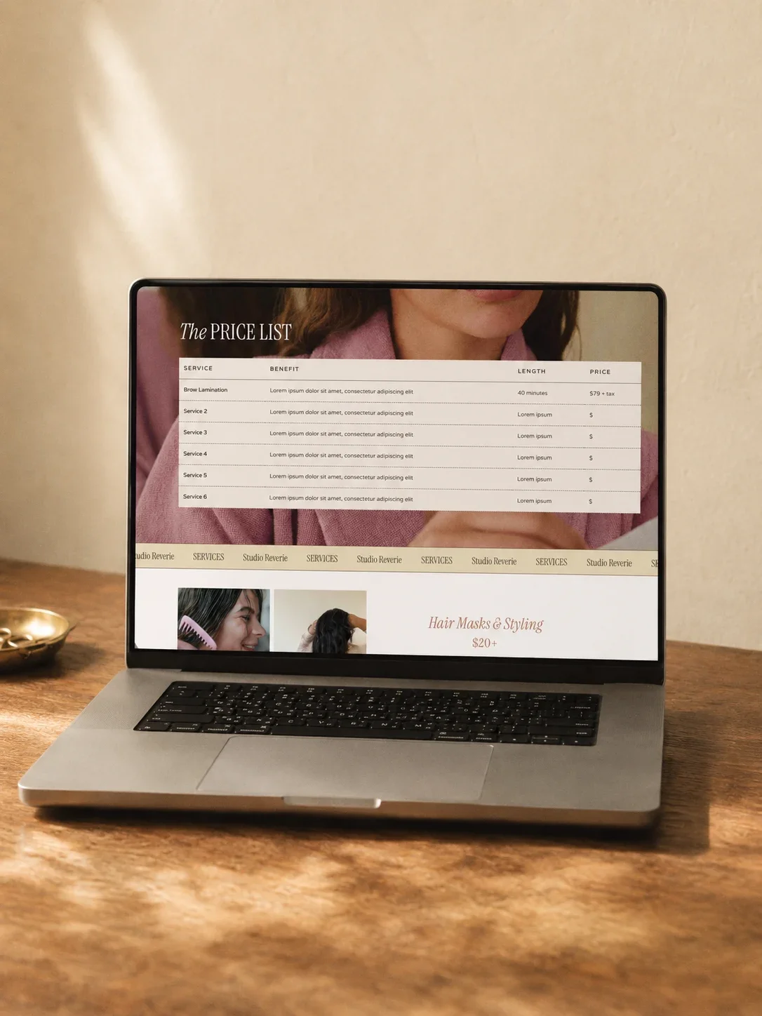 Mockup of a laptop showing a pricing list for a hair salon website