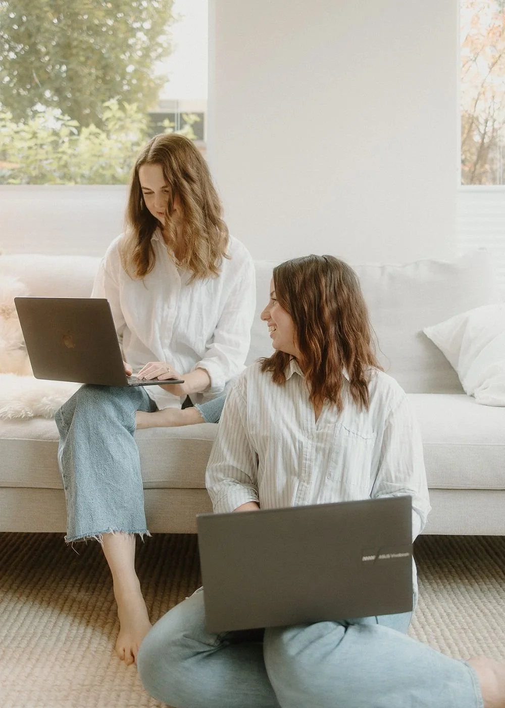 Samara Bortz and Isobel Griffin Working on Laptops on a Couch