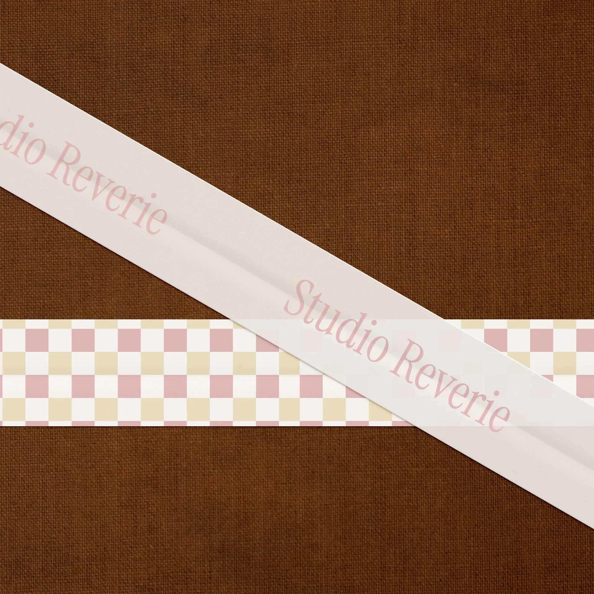 Vintage gingham ribbon on burlap texture featuring the Studio Reverie beauty brand wordmark