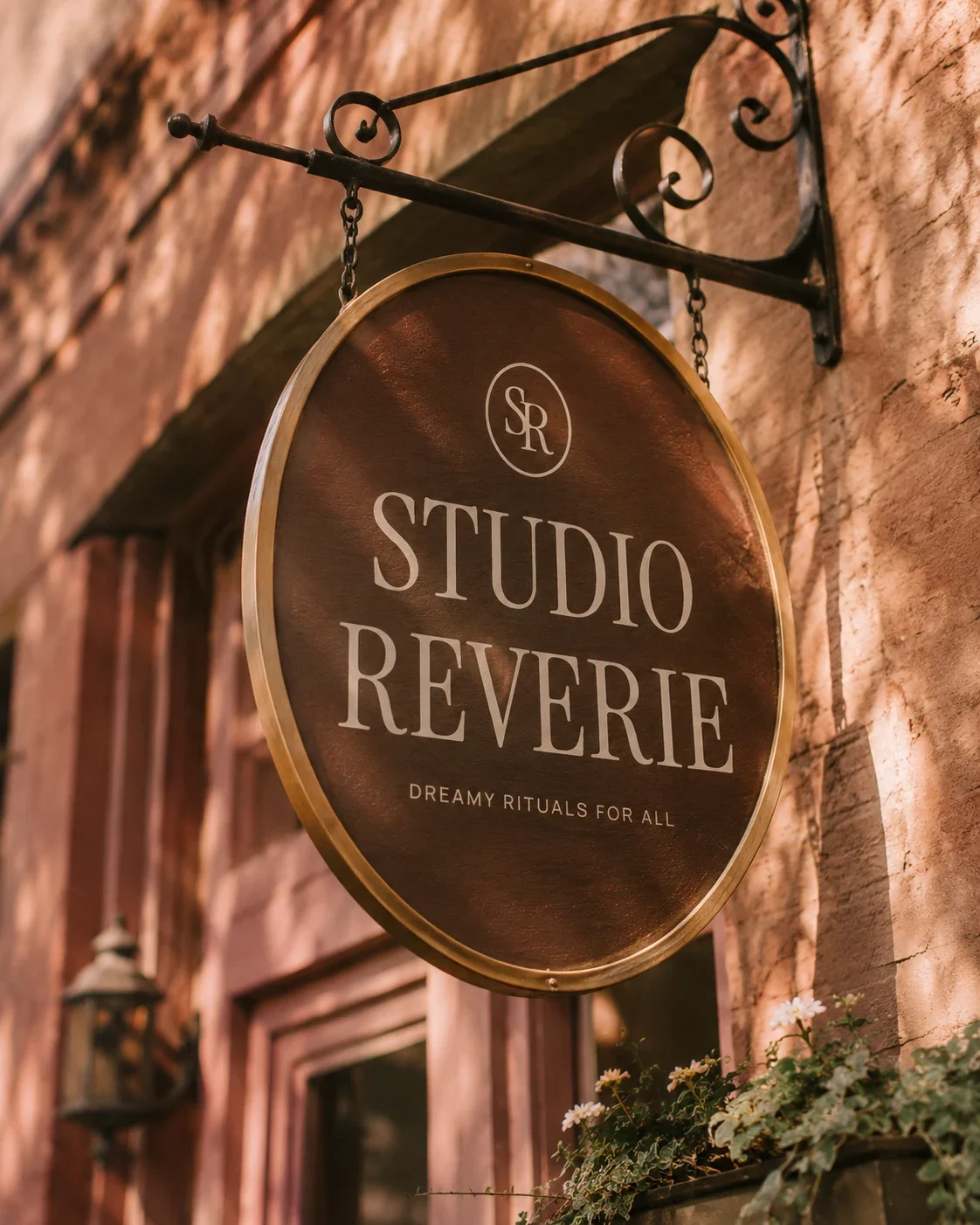 Vintage-style hanging salon sign mockup reading Studio Reverie, dreamy rituals for all