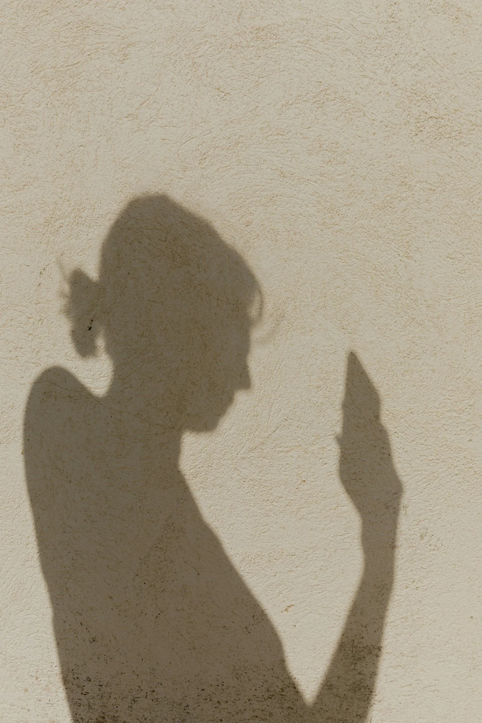 textured image of a beige stucco wall with shadows