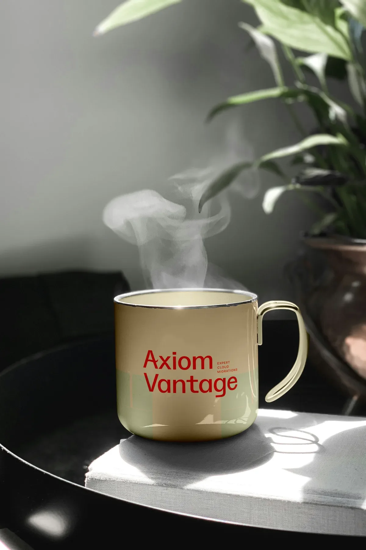 Steaming enamel mug printed with the red Axiom Vantage logo and Expert Cloud Migrations tagline