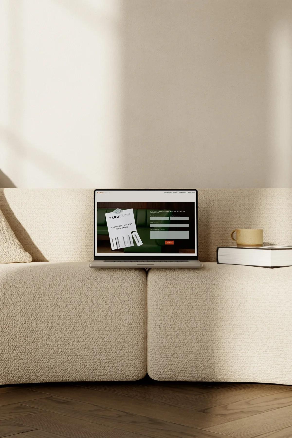Laptop mockup of the Banquette contact page with a tear-away reservation card design