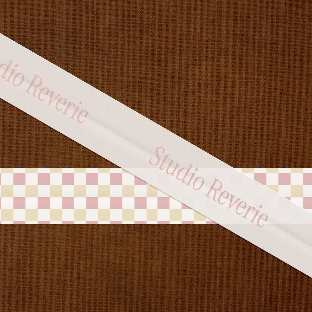 Vintage gingham ribbon on burlap texture featuring the Studio Reverie beauty brand wordmark