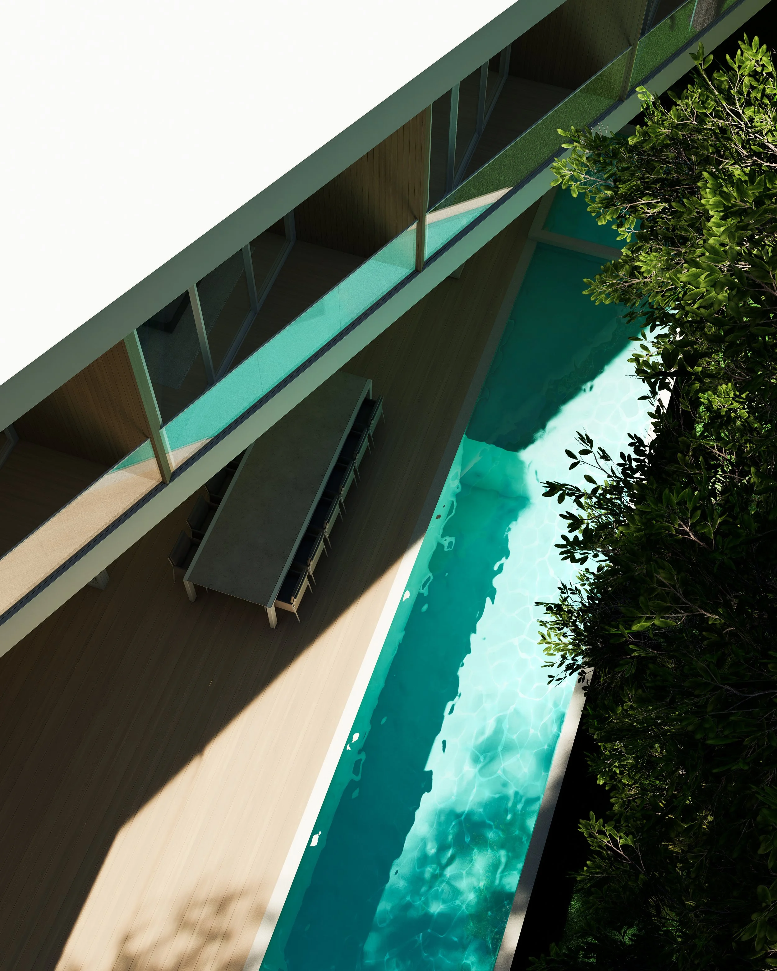 An aerial view of a modern residential building with a swimming pool on a wooden deck, surrounded by trees.