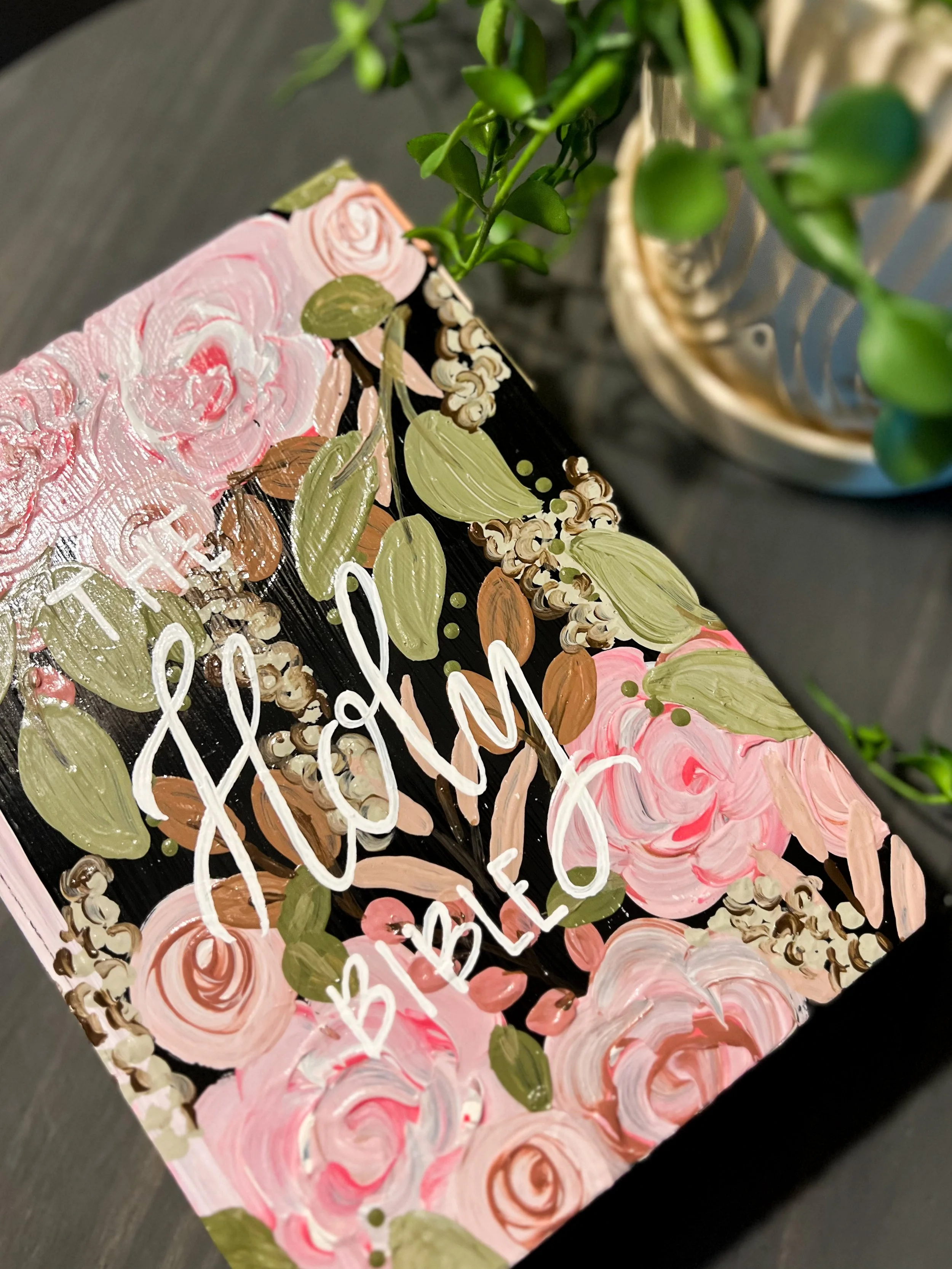 A hand-painted Mother's Day card with pink roses and green leaves, featuring the words 'Happy Mother's Day' written in white script.
